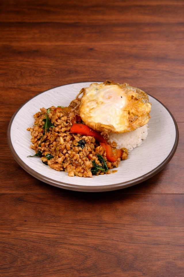 Basil ground chicken rice bowl topped with a fried egg